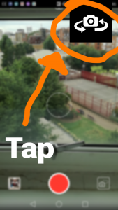 Arrow pointing to switch camera icon in top right of phone camera screen