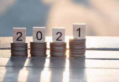 "2021" balancing on a pile of coins