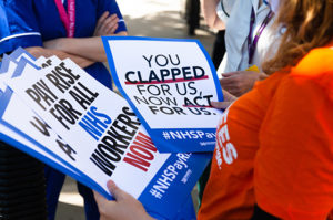 Photo of a member of the 38 Degrees staff team handing out posters about the campaign to give NHS workers a proper pay rise.