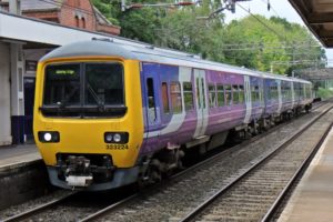 Photo of a train pulled into a railway station.