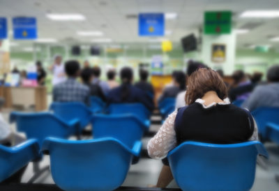 Young,Woman,And,Many,People,Waiting,Medical,And,Health,Services