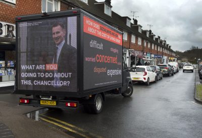 An image of an advertising van with a picture of Chancellor Jeremy Hunt on the back, and the phrase "What are you going to do about it Chancellor?"