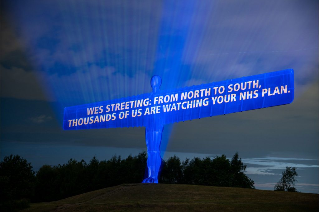 Projected onto the Angel of the North: "Wes Streeting: from North to South: thousands of us are watching your NHS plan"