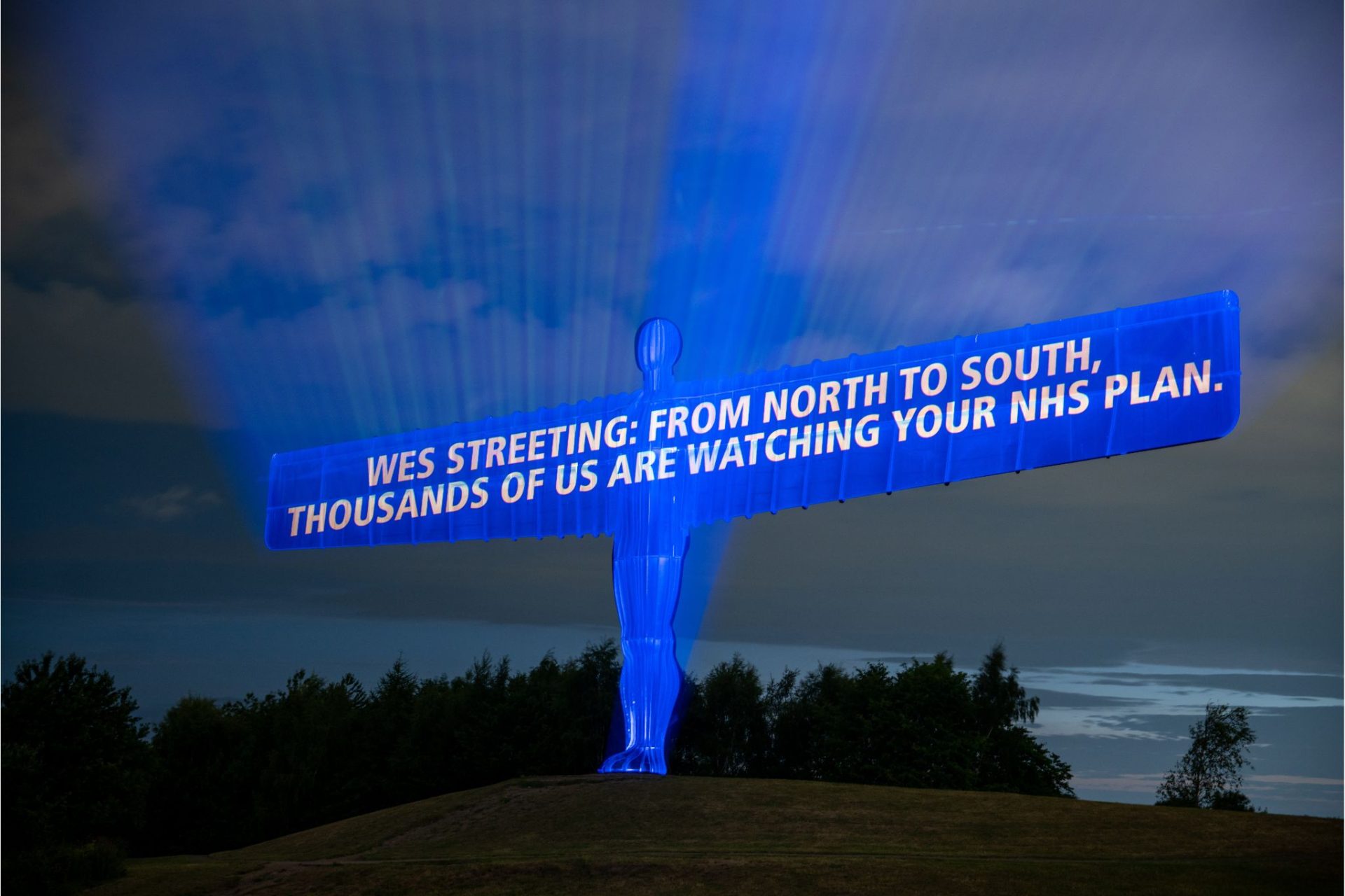 Projected onto the Angel of the North: "Wes Streeting: from North to South: thousands of us are watching your NHS plan"