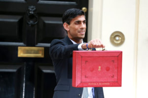 Rishi Sunak holds up a red briefcase outside number 11 Downing Street