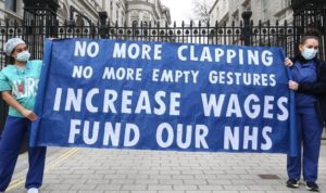 Banner reads: "No more clapping, no more empty gestures. Increase wages, fund our NHS".