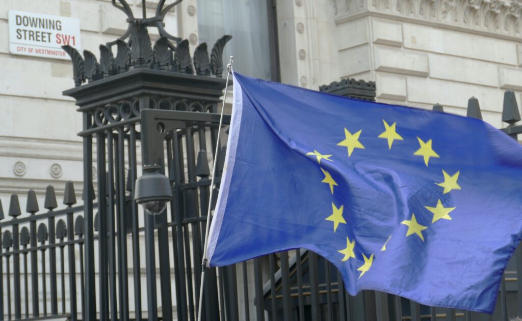 A blue and yellow European flag flies outside Downing Street