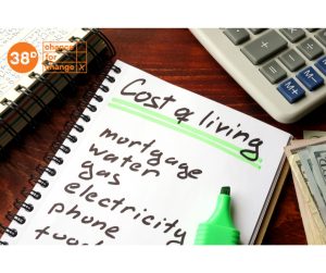 A list written on a pad of paper which says "cost of living" at the top under a list of expenses, including mortgage, electricity and food. An orange logo in the top left corner says "38 degrees, a chance for change"